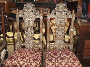 PAIR OF HEAVILY CARVED LINED OAK HALL CHAIRS