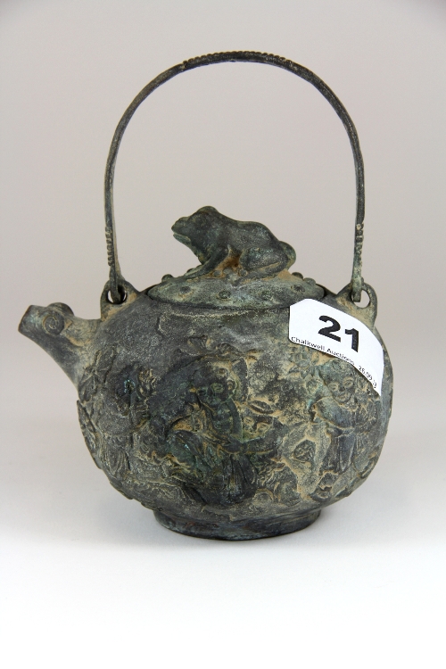 A relief decorated cast bronze tea pot H.15cm