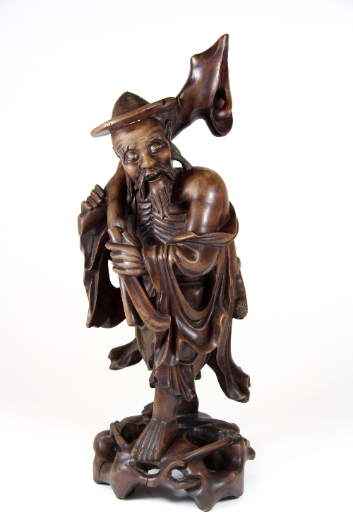 An early 20thC carved hardwood figure of a Buddhist Immortal H.38 a.f