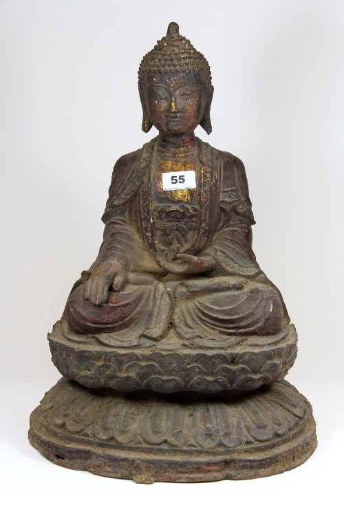 A Chinese cast iron figure of the seated Buddha with remnants of paint and gilding. H.48cm