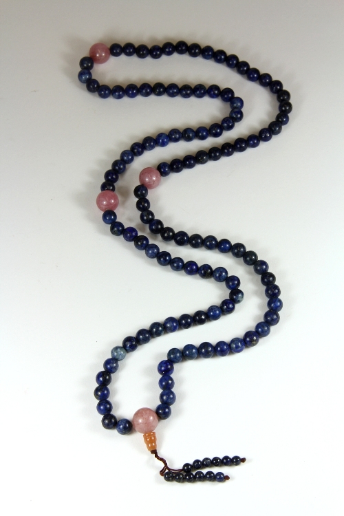 A strand of lapis lazuli and rose quartz Buddhist prayer beads.