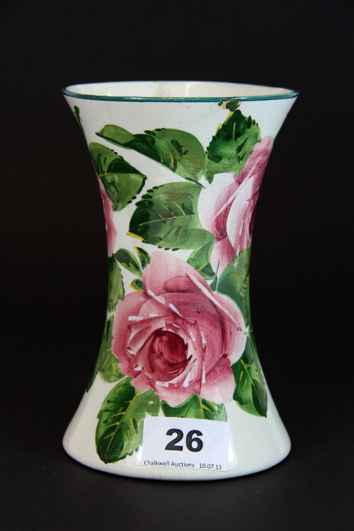 A rose decorated Wemyss ware vase. H. 16.5cms Some restoration.