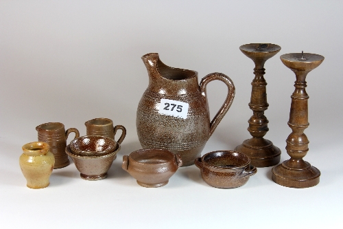 A collection of small glazed stoneware items and a pair of turned wood candlesticks