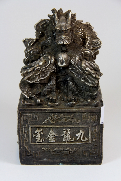 A large Chinese silvered bronze dragon seal. H 17cm x 10xm x 10xm