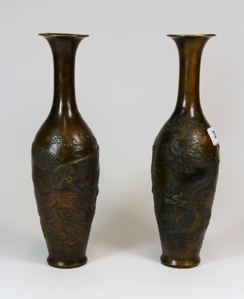 A pair of Chinese relief decorated bronze vases. H. 27.5cm