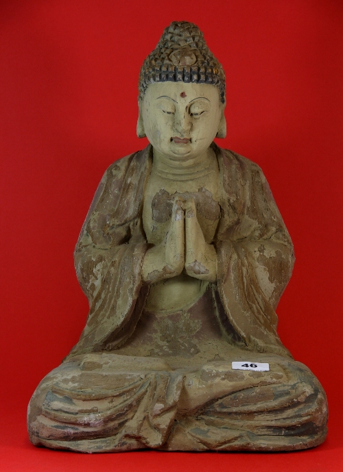 A Chinese carved wood and ghessoed figure of the seated Buddha. H.43cm