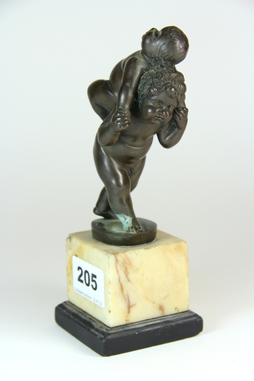 A lovely 19thC bronze of one putti carrying another on a marble and slate base. H 18cm