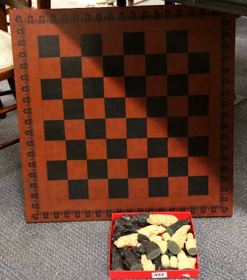 A chess board and cathedral chess set ( one rook missing)