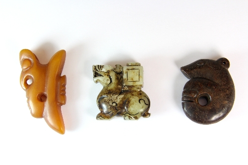 Two Chinese carved hard stone amulets and one other