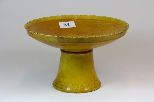 A Chinese imperial yellow glazed stem bowl with incised decoration of dragons. Dia.23cm H14cm