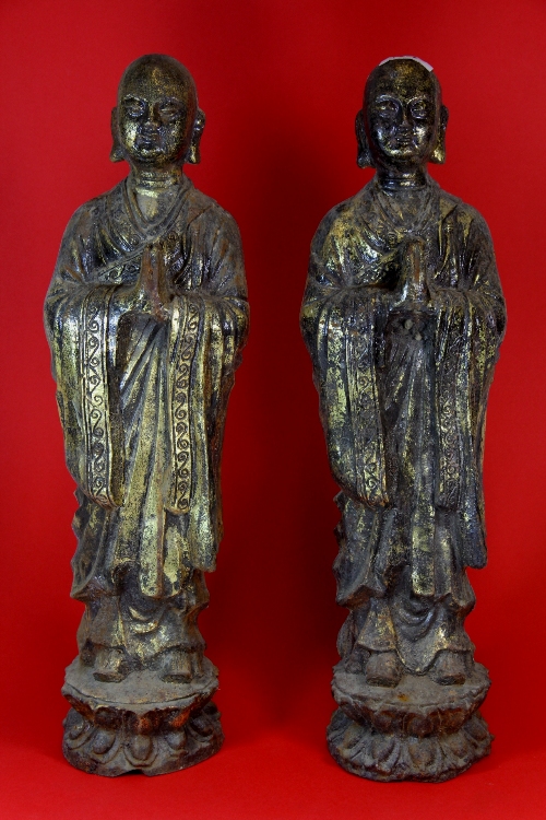 A pair of gilt cast iron figures of praying monks. H.47cm