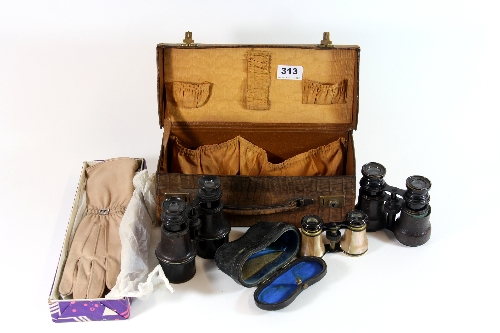 A 1920`s travelling case with a pair of mother of pearl opera glasses, two other pairs and a pair of