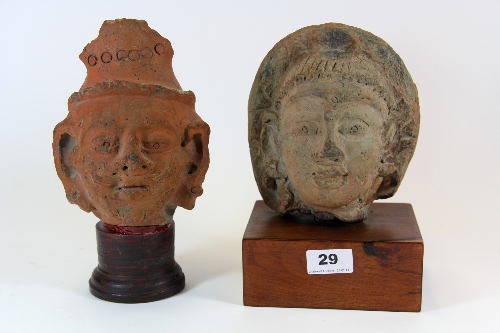 Two early Northern Indian clay heads H.25cm