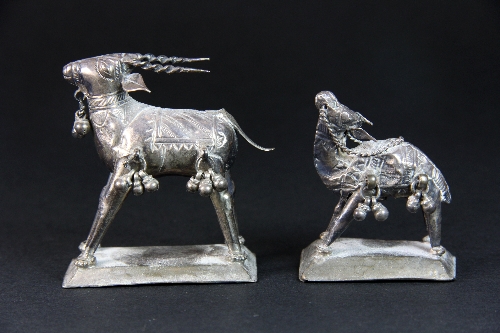 Two eastern white metal animal figures.