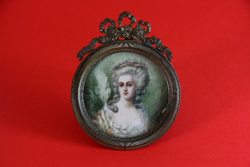 A Gainsborough style hand painted miniature (probably on ivory) in a brass frame. 7cm x 9cm