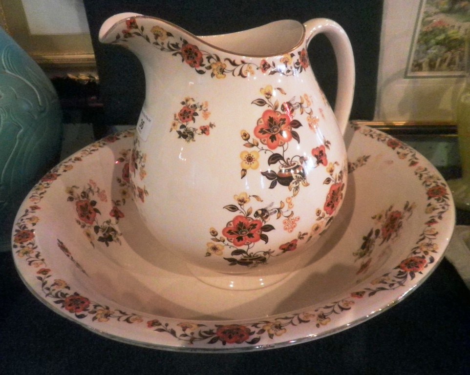 A Cauldon wash jug and basin, early 20th century, decorated with orange and yellow flowers, together