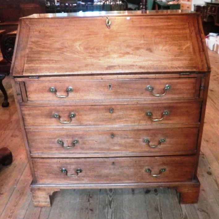 A George III mahogany bureau, having rectangular top over moulded edged fall enclosing fitted