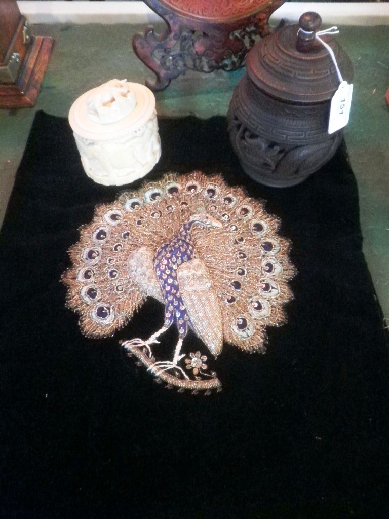 A silvered thread embroidered and sequin decorated needlework of a peacock, an early 20th century