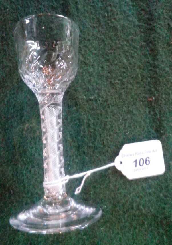 A mid-18th century wine glass, having hammered bowl, double series air twist stem on conical