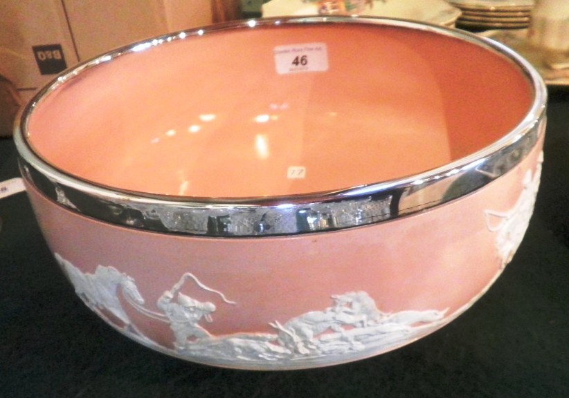 A Copeland fruit bowl, decorated in relief with hunting scenes on a peach ground with white metal