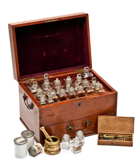 A MID 19TH-CENTURY MEDICINE CHEST, the plush-lined lid opening to reveal an array of glass-stopped