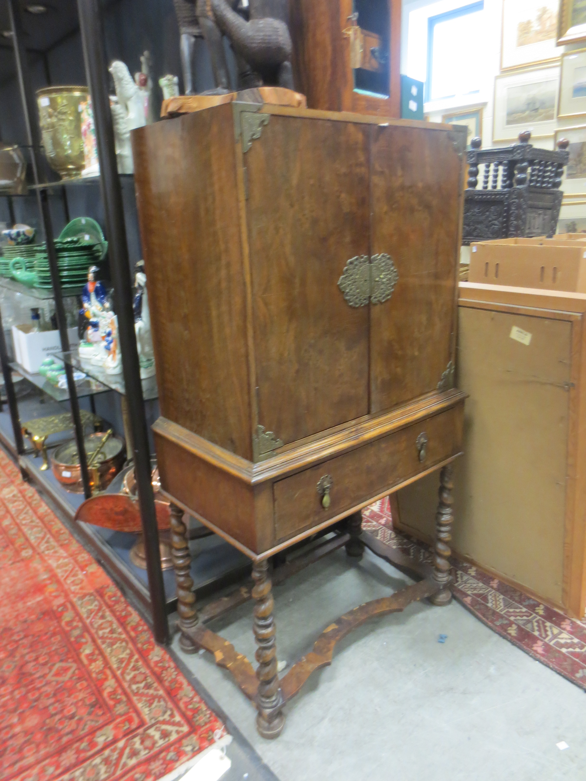 A 1930`s walnut veneered cocktail cabinet with brass mounts in the Queen Anne style A 1930`s