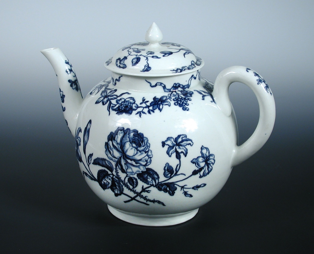 An 18th century Worcester blue and white punch pot and cover printed with roses and lilies below