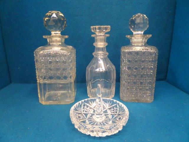 Three glass decanters including a Georgian ring neck and a cut glass ring dish.