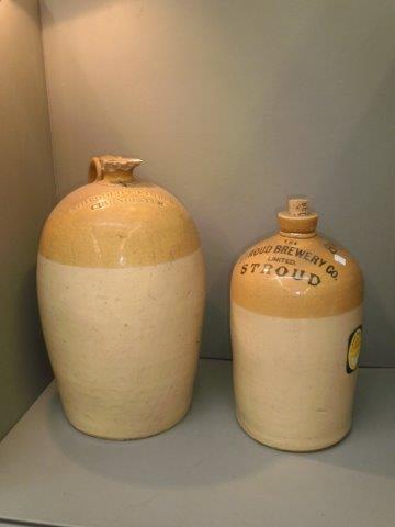 A Shirgold & Kimber, Cirencester stoneware flagon and a Stroud Brewery & Co stoneware flagon.