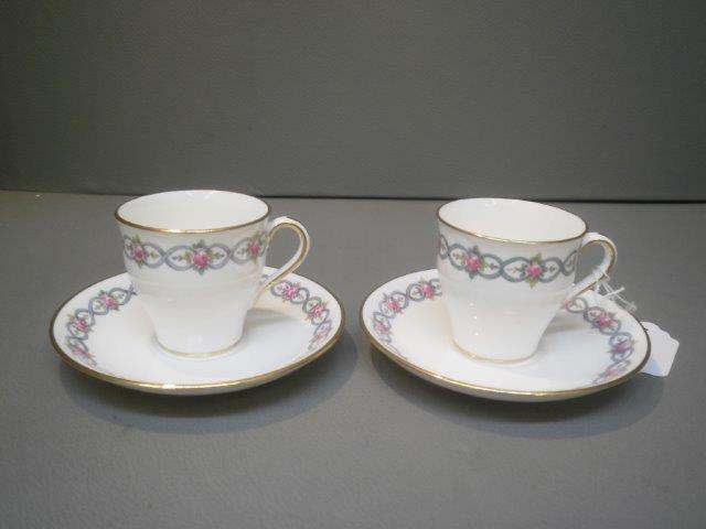 A pair of late 19th Century Mintons hand painted coffee cups and saucers.