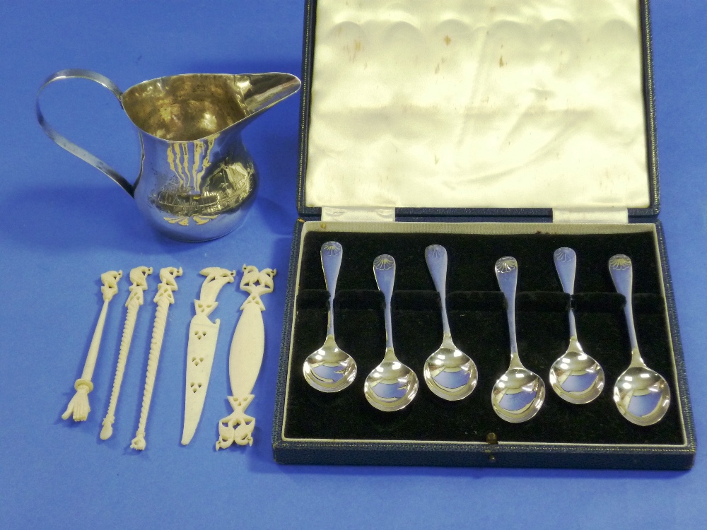 A set of six silver Teaspoons, hallmarked Birmingham, 1963, cased, together with an Egyptian white