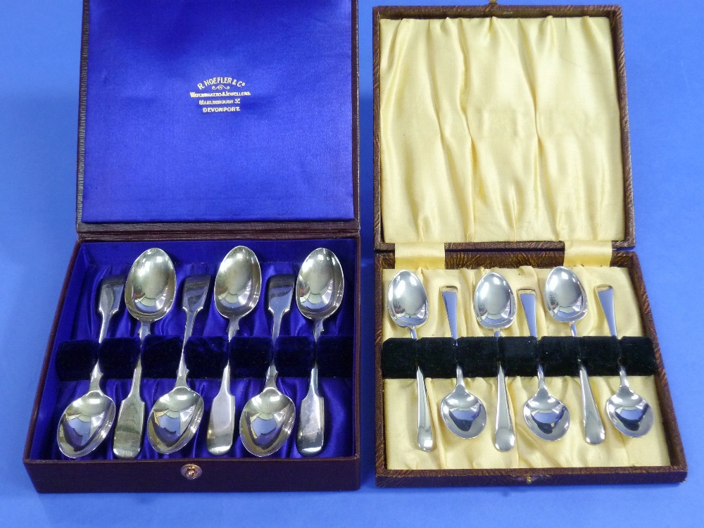 Six silver teaspoons; in a display box, together with another set of six silver teaspoons in a