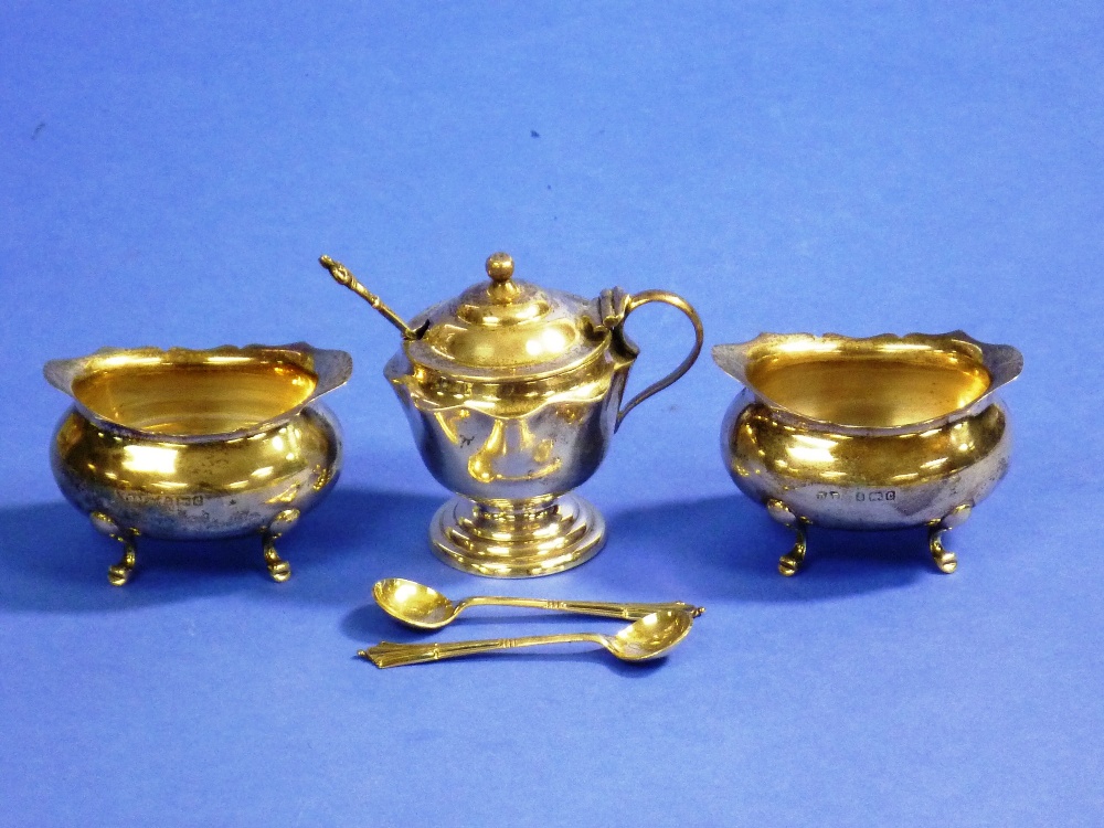 A three-piece silver Cruet set, hallmarked Birmingham, 1902 and 1904, comprising two salts and a