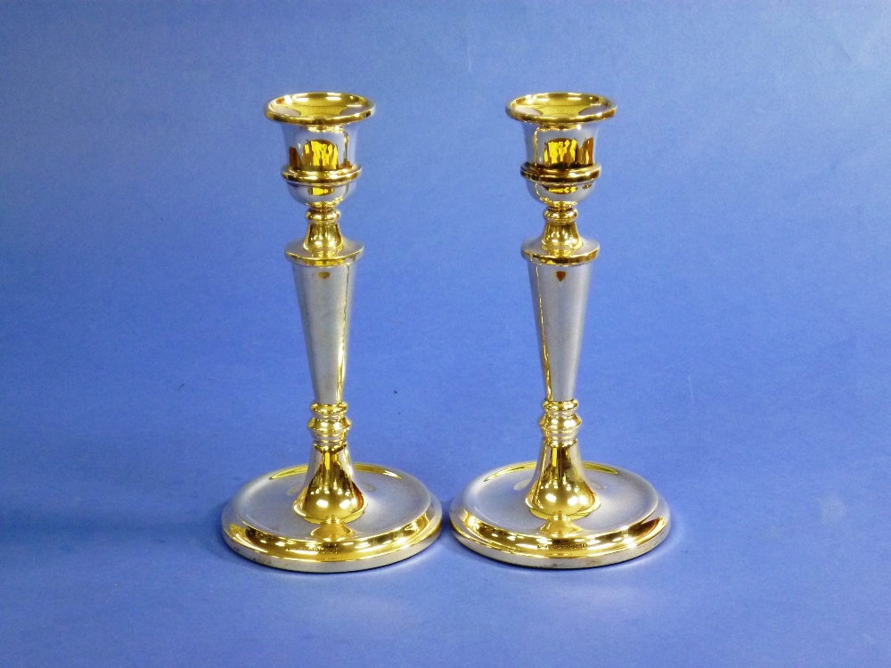 A pair of modern silver Candlesticks, hallmarked Birmingham, 2005, with vase shaped capitols on