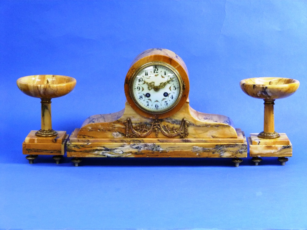 A Sienna marble three piece Clock Garniture, the drum shaped clock with a convex bezel on a plinth