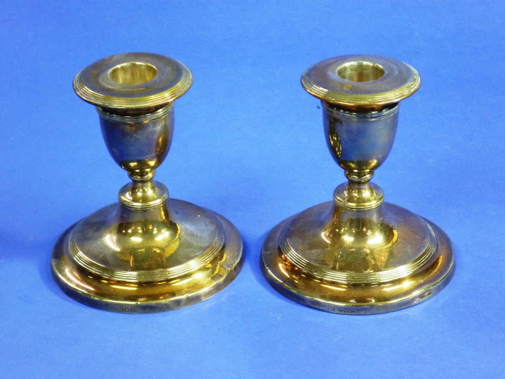 A pair of George V silver short Candlesticks, hallmarked Birmingham, 1912, with reeded decoration,