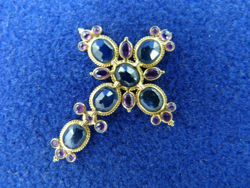 A yellow gold mounted Cross; 1½in (4cm) high, set with six oval blue sapphires and with small pink