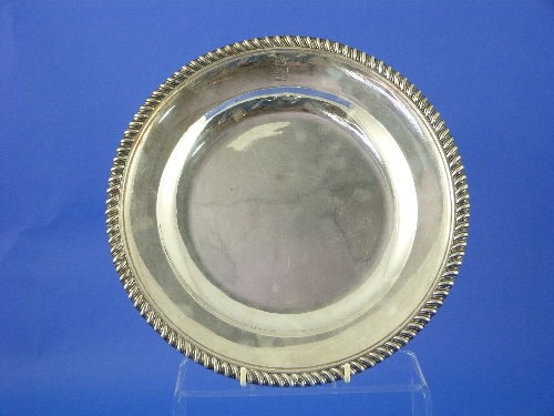 A French silver circular plate by Odiot, Paris, the rim with gadrooned border, engraved with the