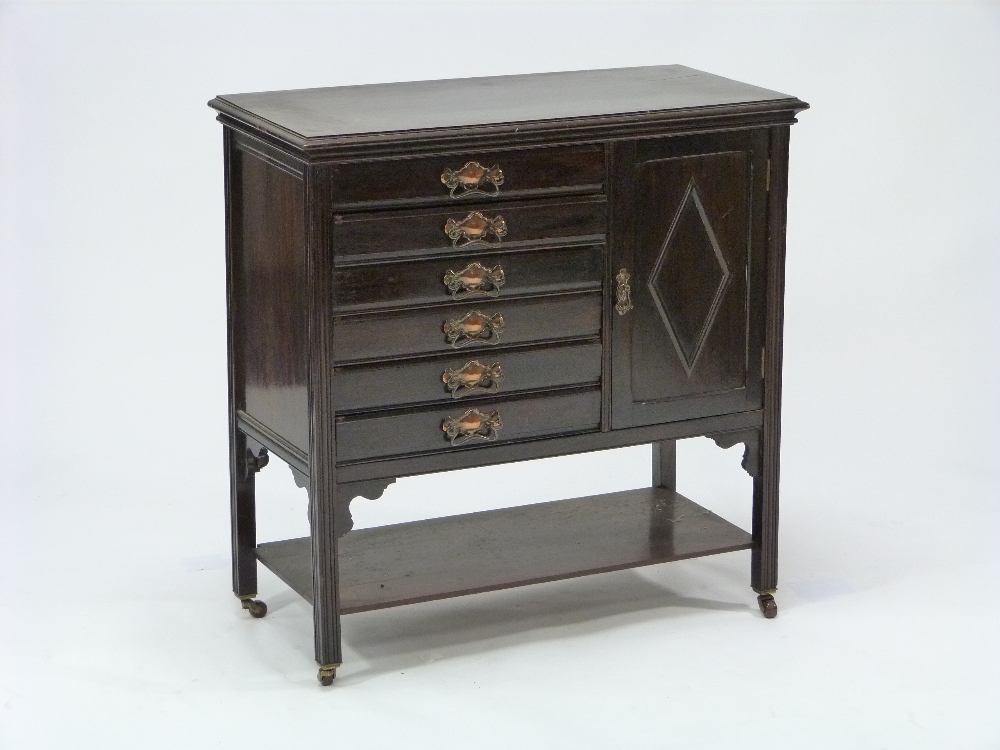 A stained beech Music Cabinet, with six fall front sheet music drawers and a cupboard above an