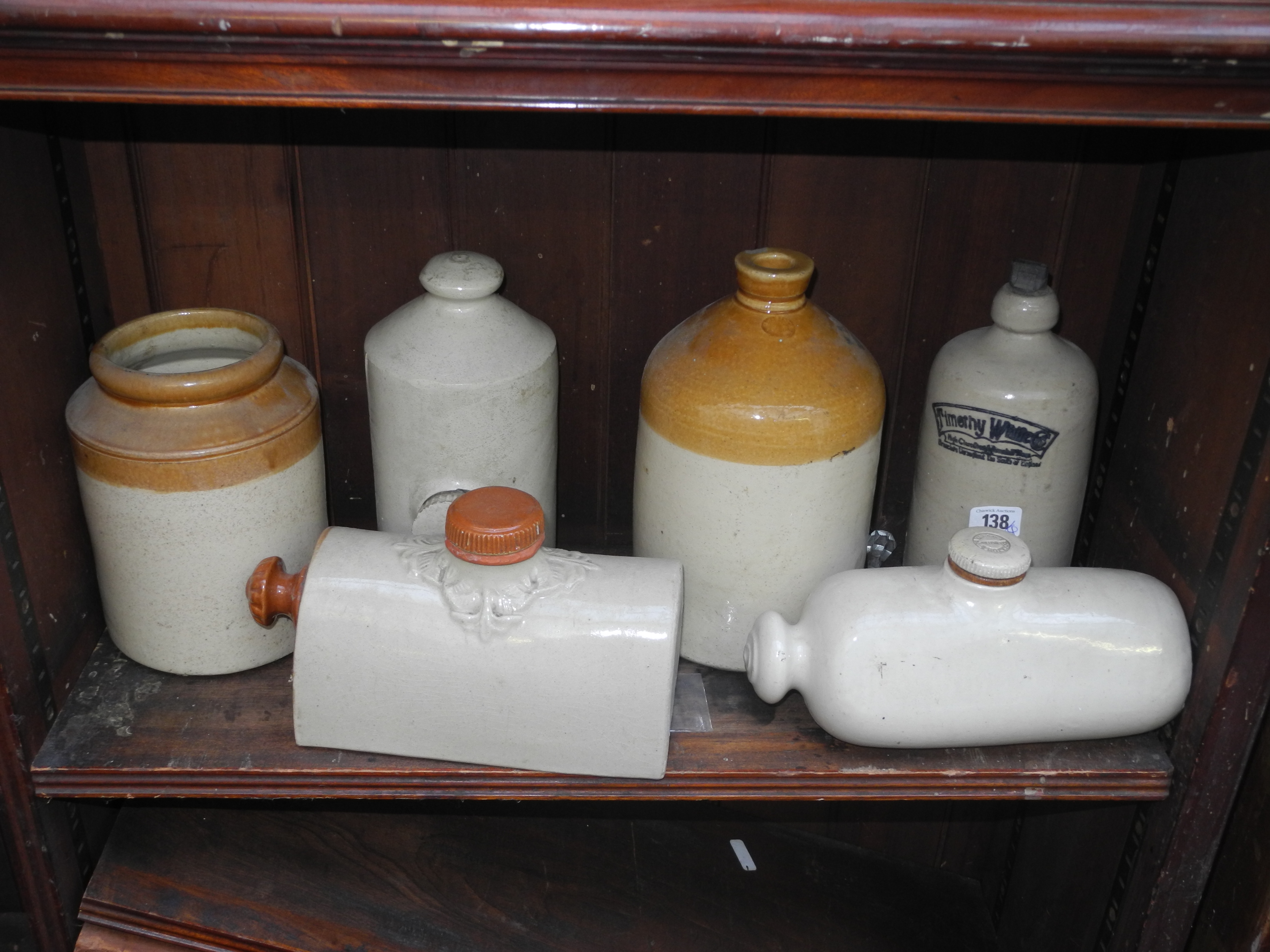 A quantity of early glass bottles and stoneware jars and bottles, including many with trade