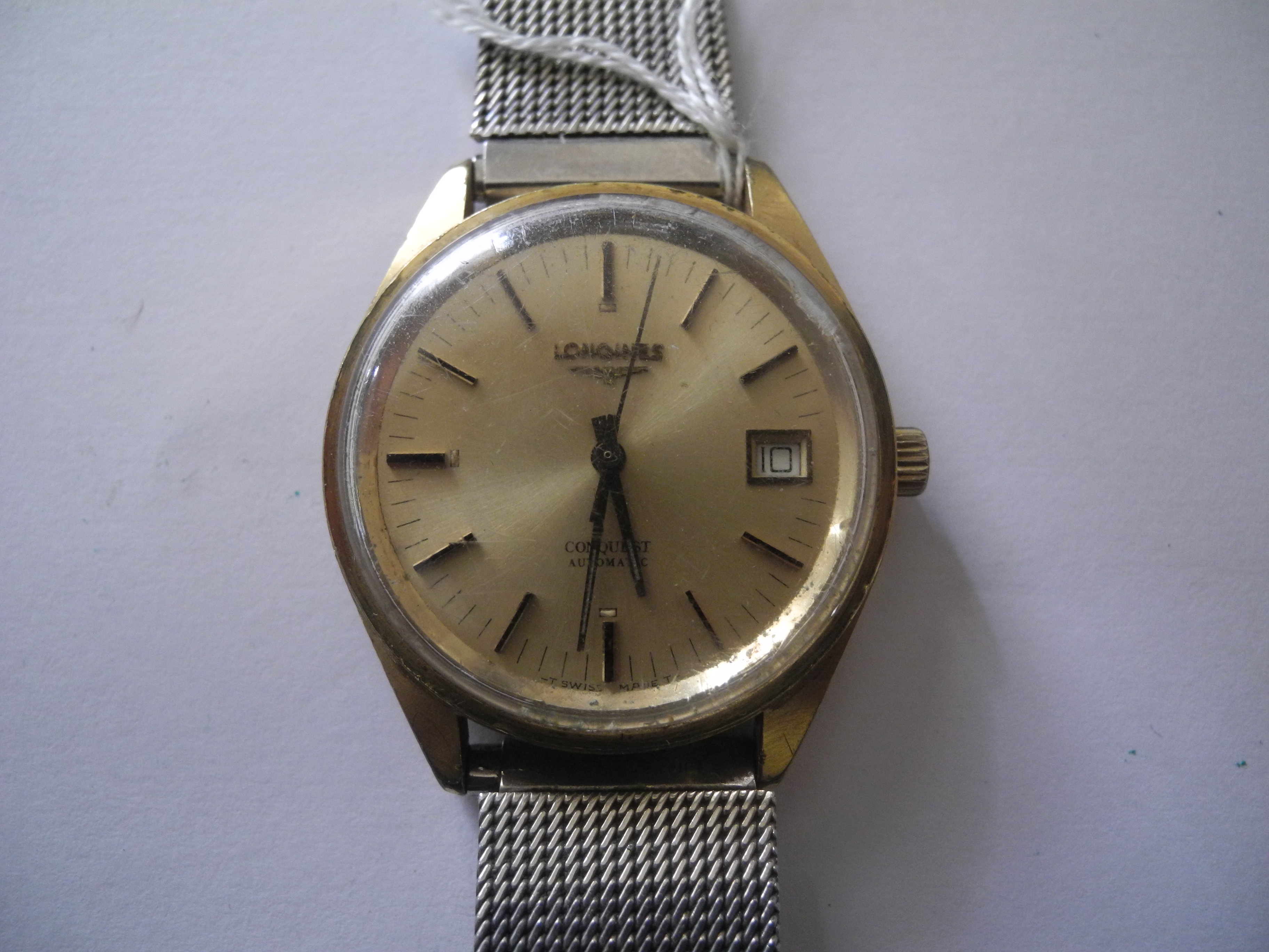 A gent`s gold plated Longines Conquest wrist watch, with gilt date dial and enamelled batons (AF).