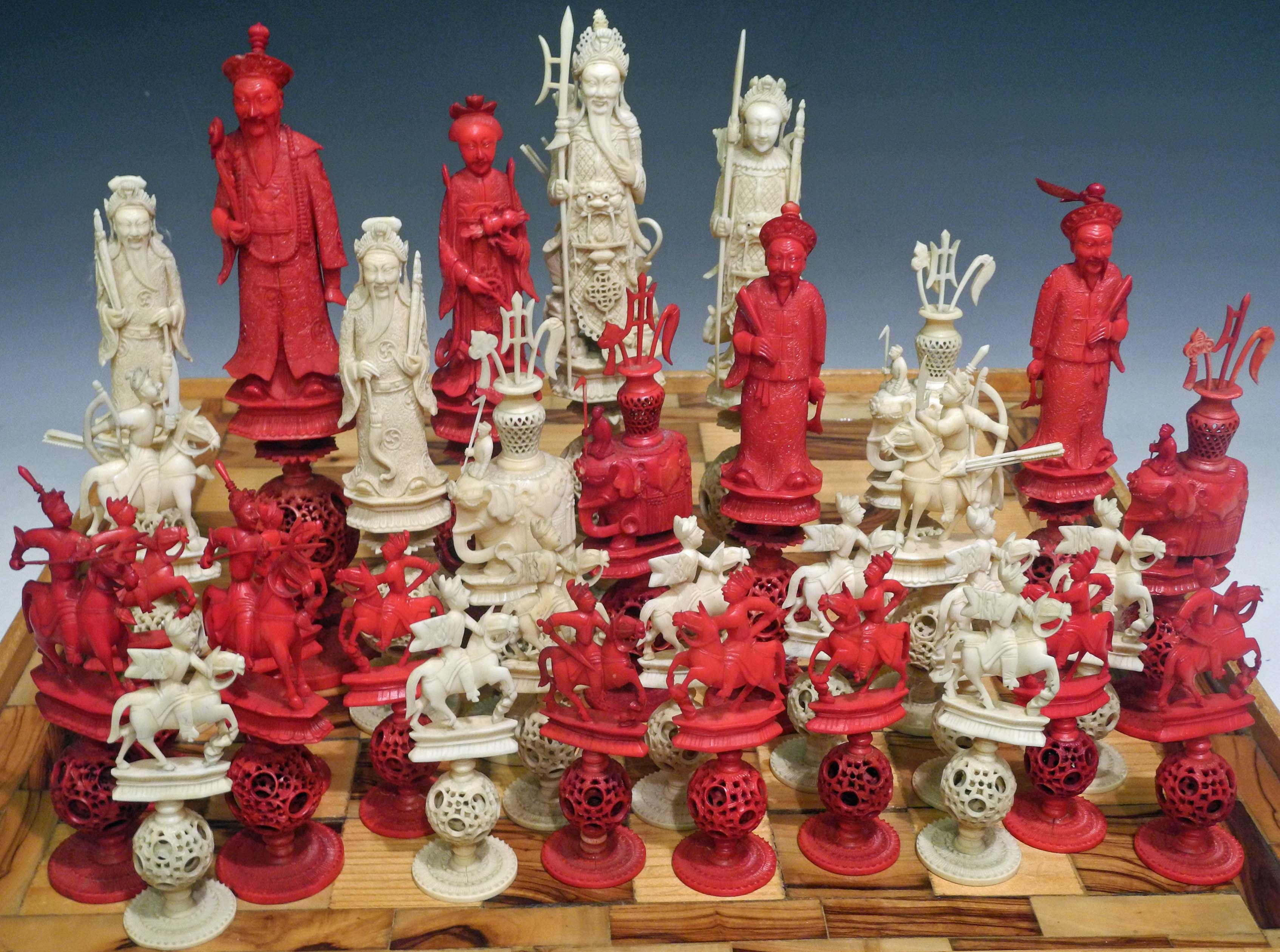 A fine 19th Century Chinese carved ivory chess set, the chess pieces are carved to represent a
