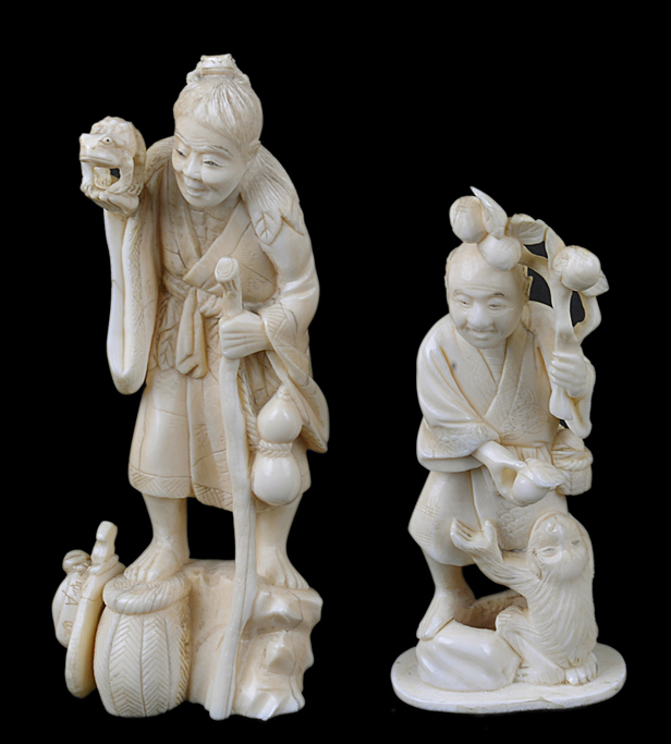 A Japanese antique ivory carving of an old lady holding a frog, together with another carving of a