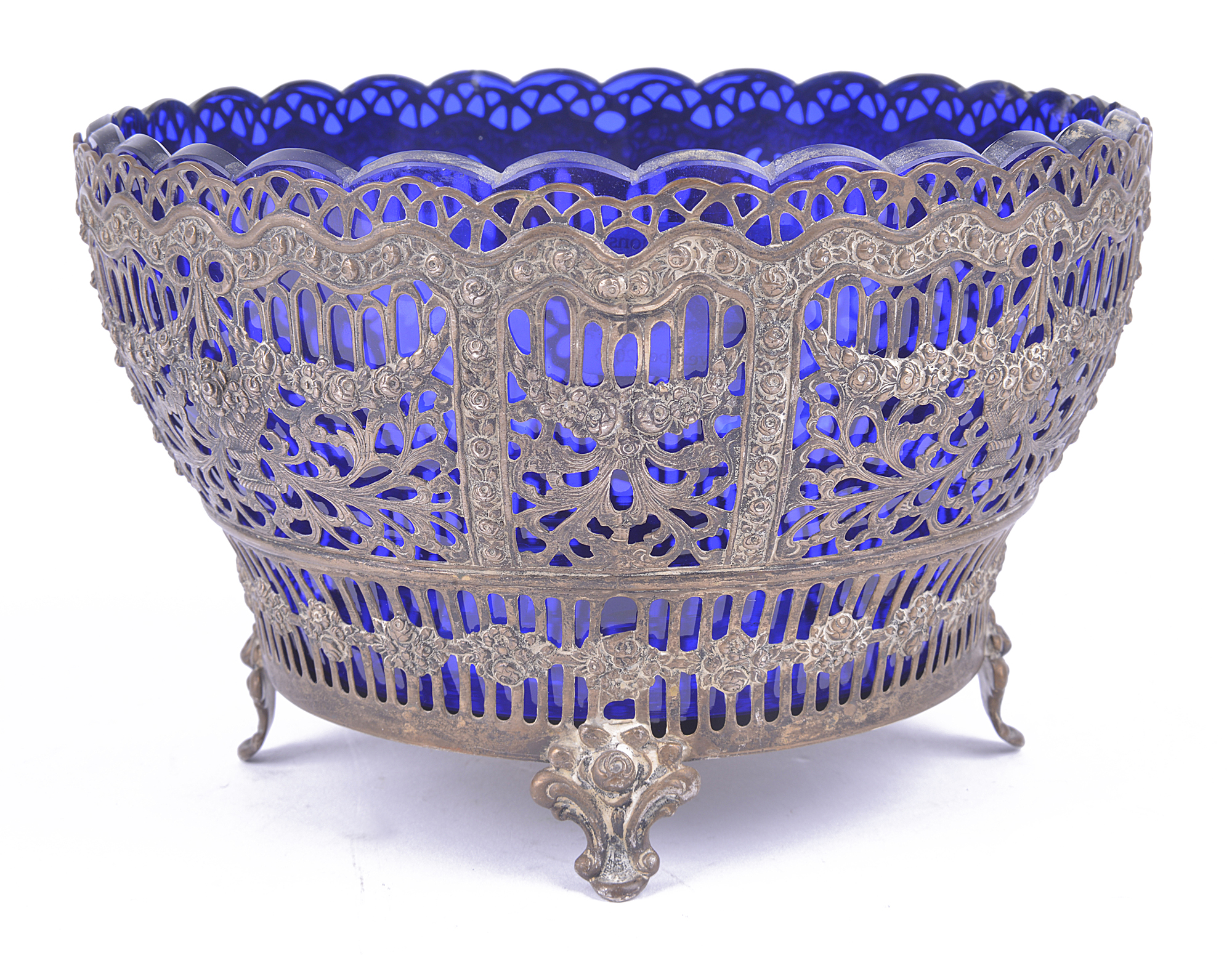 A late 19th Century .800 white metal pierced bowl, with blue glass liner.