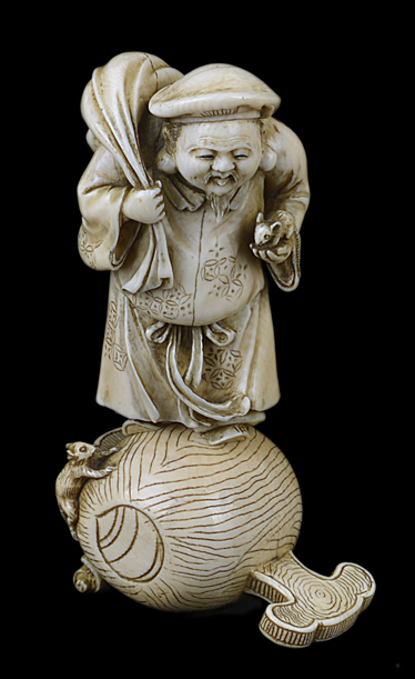 A good 19th Century carved ivory okimono of a sage carrying a sack and a harvest mouse.11cm high