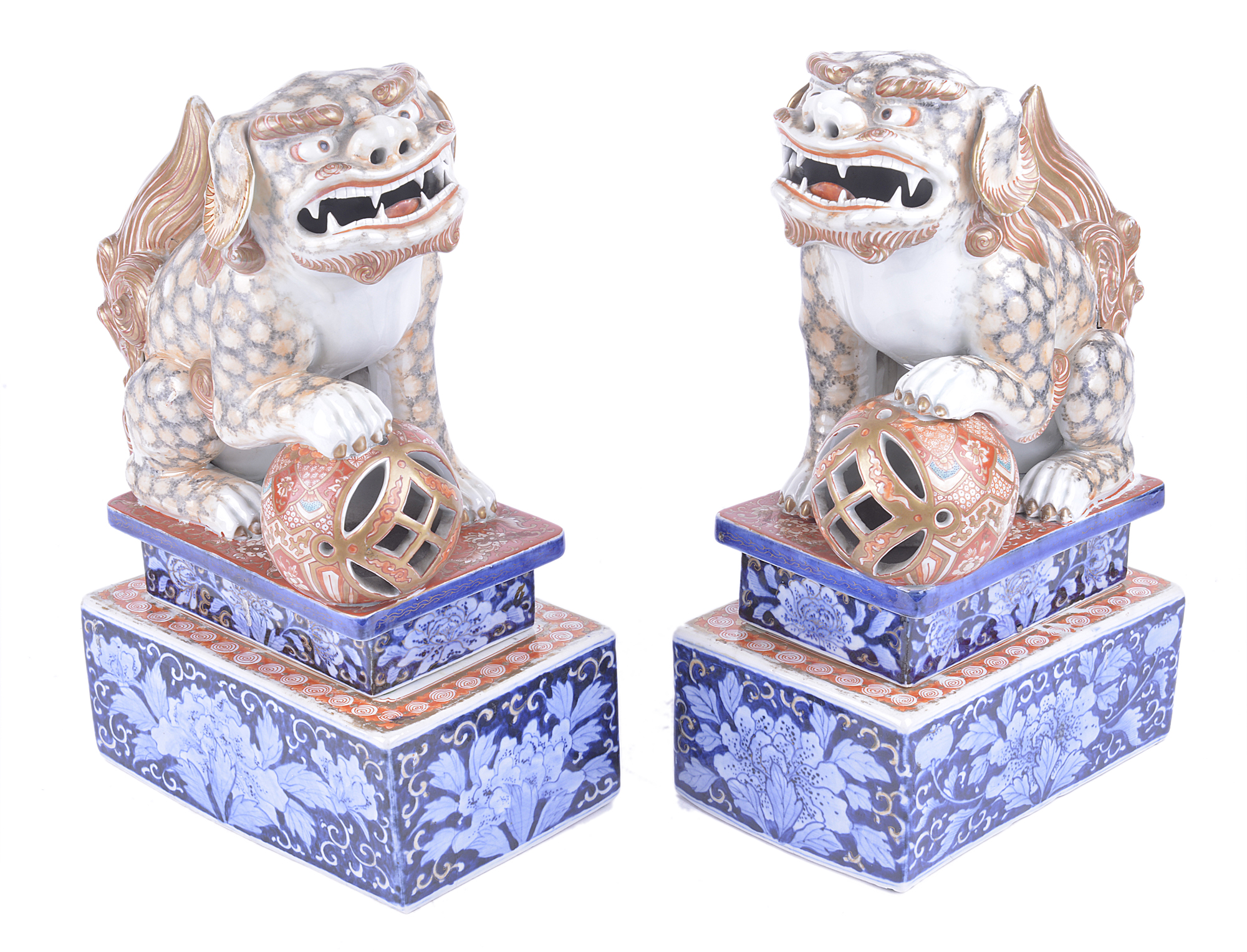 A pair of Japanese 19th Century Meiji porcelain foo dogs, in Satsuma palette and raised on brick