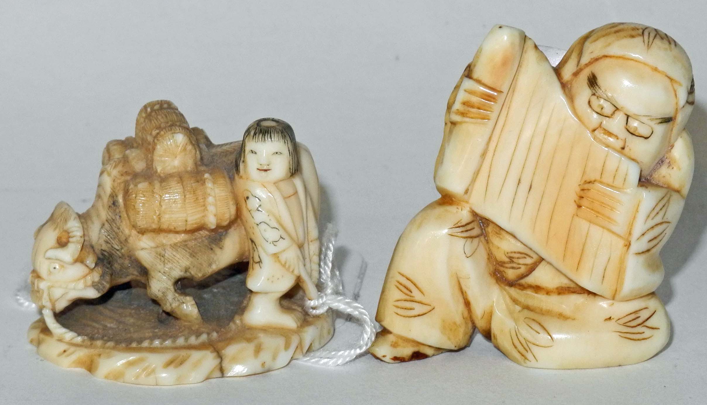 An 19th Century ivory netsuke of an ox and handler, together with two other netsukes. (3)2.6cm, 6.