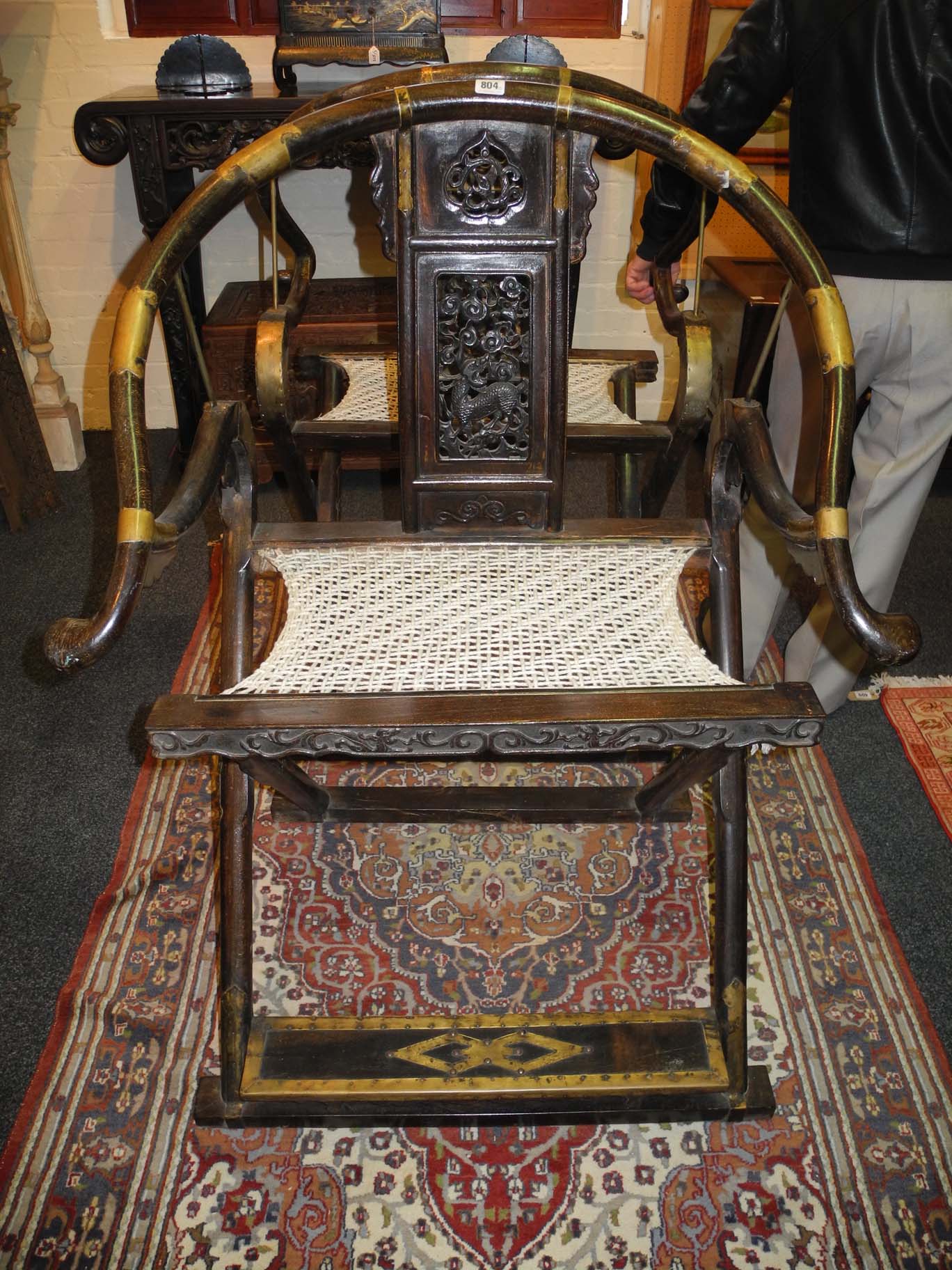 A pair of 19th Century Chinese Qing Dynasty folding horseshoe armchairs, having pierced back support