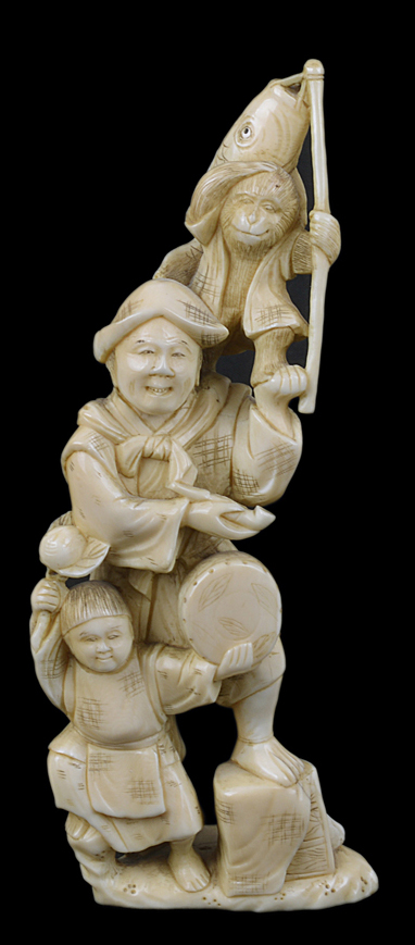 A Japanese antique ivory of a group, including three figures with a monkey.15cm
