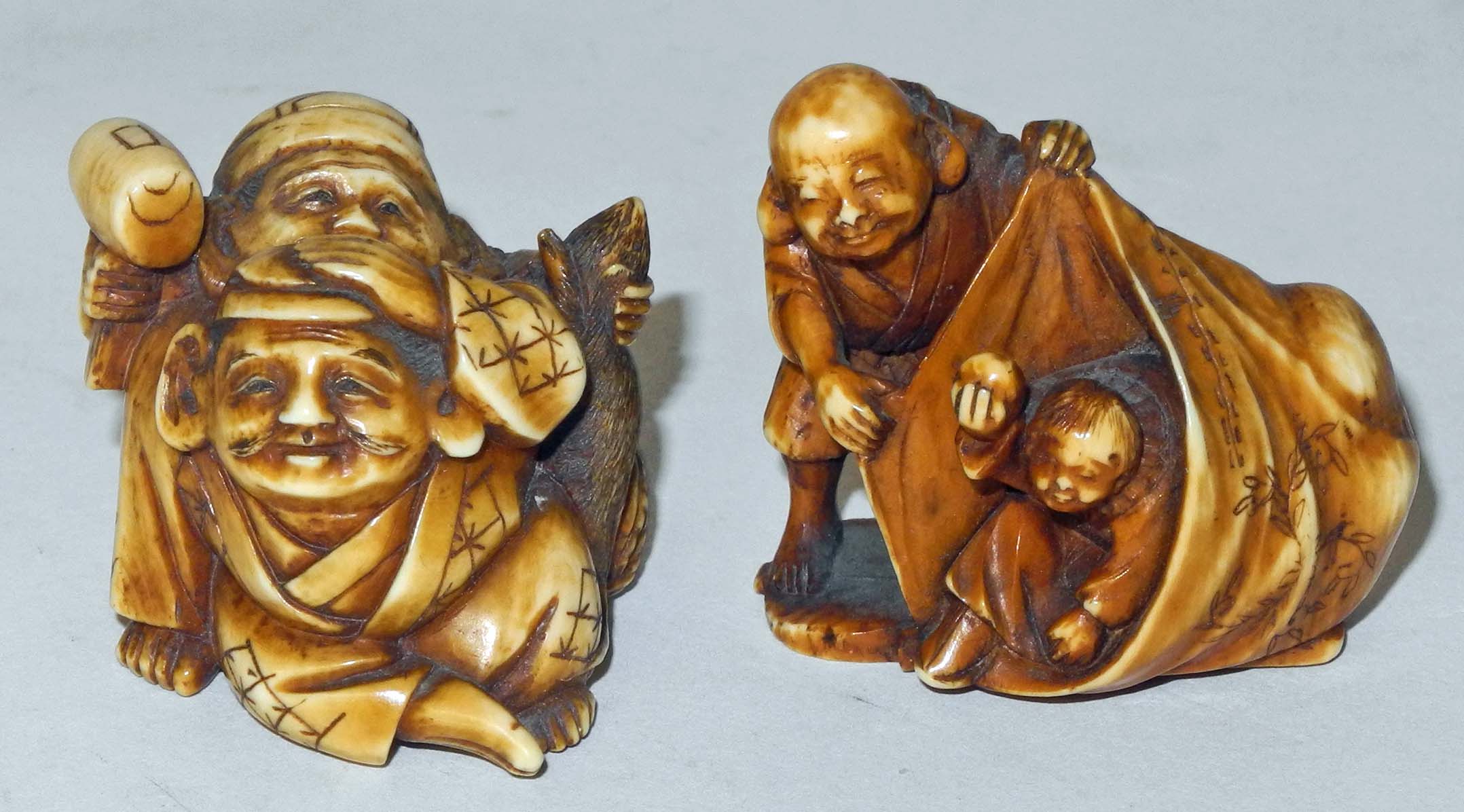 A Japanese ivory netsuke of a man opening a bag revealing a child playing inside, together with